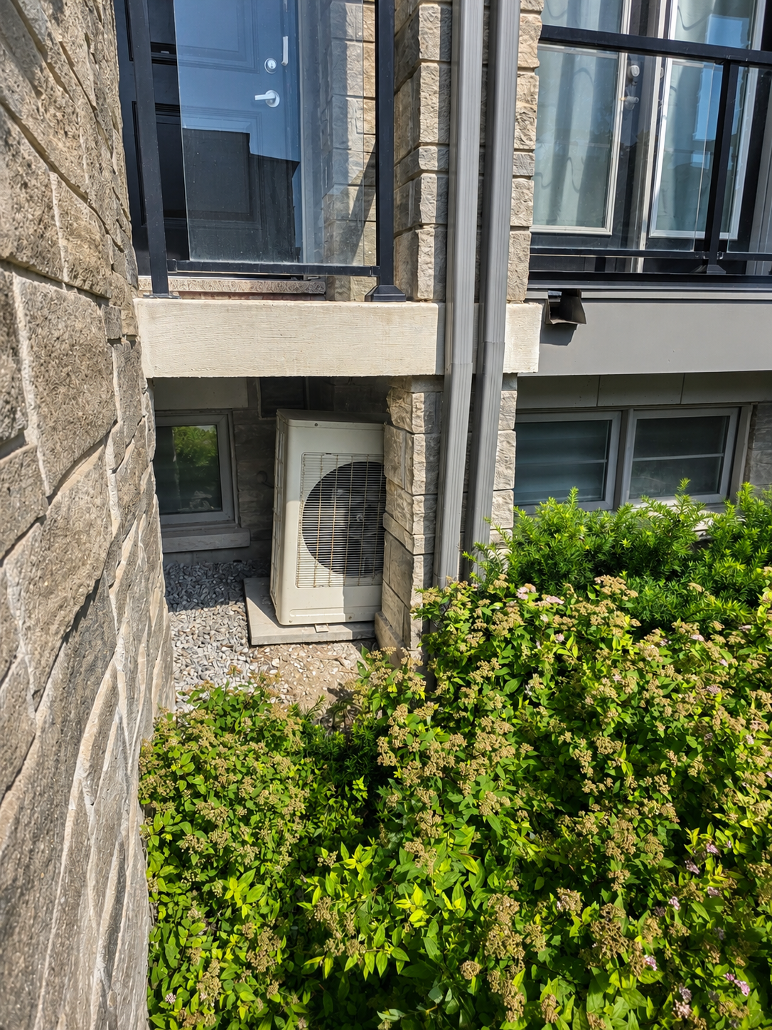 AC unit installed on exterior of stone building
